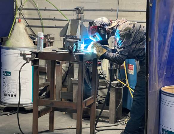 Skilled welder focusing on precision manual welding.